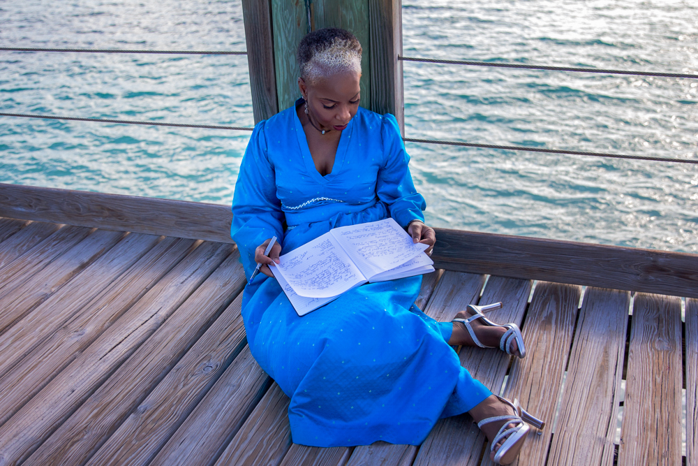 woman journaling by the sea